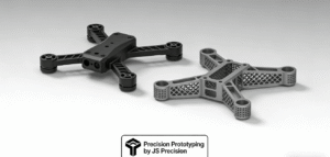 A CNC machined black polymer drone arm component and a titanium aerospace bracket made via metal 3D printing, showcasing professional rapid prototyping capabilities